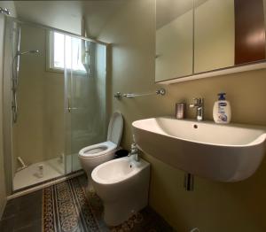 a bathroom with a sink and a toilet and a shower at San Liberale sul mare in Trapani +23 photos