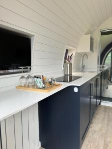 a kitchen with a counter with a sink and a counter sidx sidx at Luxury Glamping In North Yorkshire National Park & Coastal Area in Scarborough