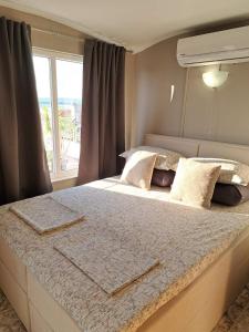 a bedroom with a large bed with a window at The White House in Nesebar