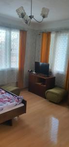 a bedroom with a bed and a desk with a computer at Къща за гости in Razgrad