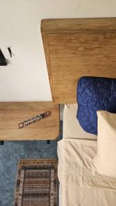 a bed with a wooden head board with a pen on it at Casa Foto Estudios in El Cuyo +56 photos