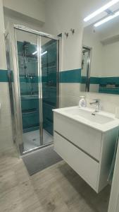 a bathroom with a white sink and a shower at Casa vacanze Ricky in Porto Recanati