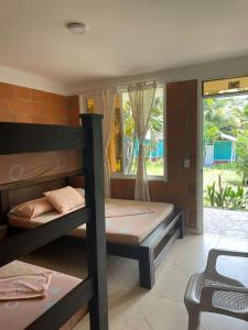 a room with two bunk beds and a window at Hotel Costa Real in Playa Ladrilleros