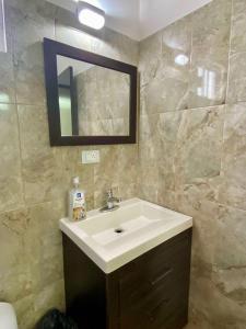 a bathroom with a sink and a mirror at Departamento Océano in La Paz