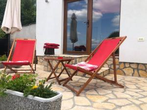 two chairs and a table on a patio at Perla Apartments Opatija - apartments with sea view in Opatija
