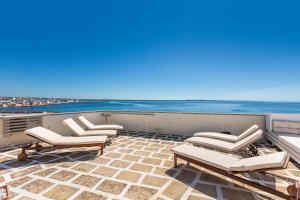 a balcony with chairs and a view of the ocean at Casa Kalè by BarbarHouse in Gallipoli