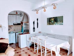 a kitchen with a table and chairs in a room at La dimora di nonna Giuliana in Ostuni