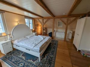 a large bedroom with a bed and a rug at Ostsee Stadthus in Heiligenhafen