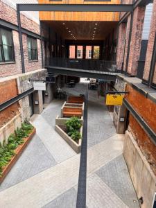 a view of a building with a courtyard with benches at Prime 2BR Condo Historic Morris Ave, Downtown Birmingham in Birmingham +6 photos