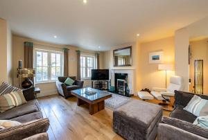 a living room with a couch and a table at Spacious home to sleep 8 just a short stroll from Kenmare in Kenmare