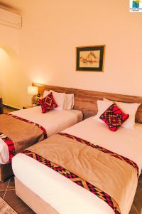 a hotel room with two beds in a room at Seti Abu Simbel Lake Resort in Abu Simbel
