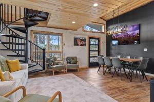 a living room with a staircase and a table and chairs at Hottub Haven BHBungalows #9 in Custer