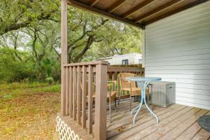 a wooden deck with a table and a table at Quaint Texas Studio 1 Mi to Rockport Beach! in Rockport