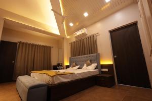a bedroom with a bed with a yellow comforter at Lavender Heights in Lonavala
