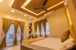 a bedroom with a bed and a ceiling at Lavender Heights in Lonavala