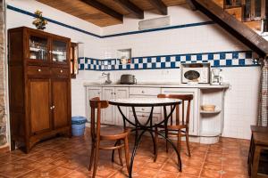 a kitchen with a table and chairs in a room at La Fragua Castiellu in Bimenes