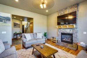 a living room with a couch and a fireplace at Townhome with Outdoor Pool Access 6 Mi to Park City in Heber City