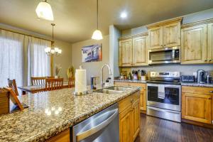 a kitchen with wooden cabinets and a counter top at Townhome with Outdoor Pool Access 6 Mi to Park City in Heber City