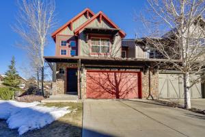 a house with a red garage on a driveway at Townhome with Outdoor Pool Access 6 Mi to Park City in Heber City