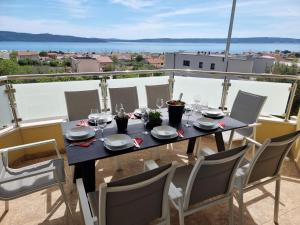 a table on a balcony with a view of the water at Villa Rocco Private Saltwater Pool Split in Kaštela
