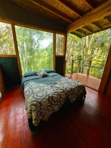 a bedroom with a bed in a tree house at La Cabaña Musical in Medellín