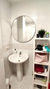 a bathroom with a sink and a mirror at O Pindo in O Pindo