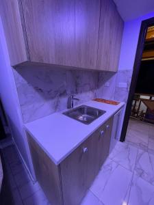 a kitchen with a sink and marble counter top at La Hacienda Cyprus in Limassol