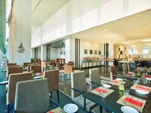 a restaurant with tables and chairs and a bar at Vivanta Pune, Hinjawadi in Pune