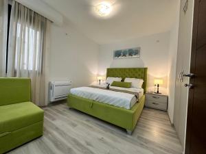 a bedroom with a green bed and a green chair at Apartment Ema Star in Utjeha