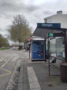 a bus stop with a sign on the side of a street at Appartement lumineux et spacieux 70m2 proche de tout - 3 chambres in Nantes