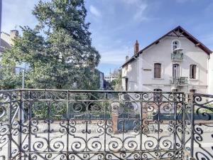 una valla de hierro frente a una casa blanca en [L'Abbat-Jour] Le Massey • Calme • Lumineux en Tarbes