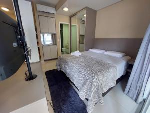 a small room with a bed and a mirror at Book Santos Unlimited 817 Elegancia Vista Mar in Santos +37 photos