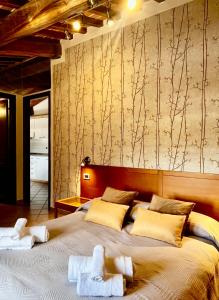 a bedroom with a large bed with towels on it at Residence Internazionale in Pietrasanta