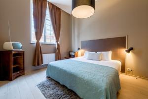 Een bed of bedden in een kamer bij Smartflats City - Brusselian