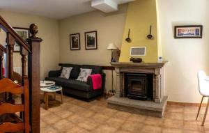 a living room with a couch and a fireplace at Casitas Del Huerto in La Alberca