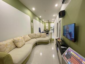 sala de estar con sofá y TV de pantalla plana en Bandar putra Ktv Snooker BBQ/IOI Mall/JPO/Aeon/Senai Airport/Kulai en Kulai