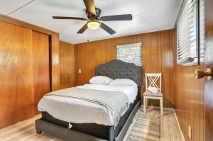 Ocala Farm Lake House في Ocklawaha: غرفة نوم مع سرير ومروحة سقف