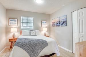 a bedroom with a white bed and a window at Private and Picturesque Escape on Lake Henry! in Lake Placid