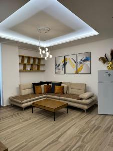 a living room with a couch and a coffee table at oasis apartment in Sarandë