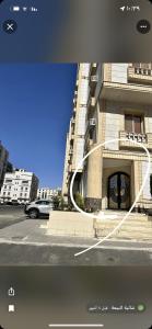 a picture of a building with a car on a street at شقة مفروشة راقية in Al Ḩawīyah