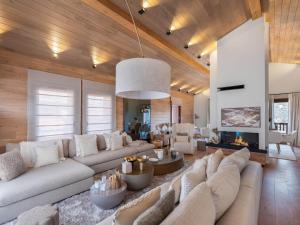 a living room with a large couch and a fireplace at Chalet Courchevel 1650, 6 pièces, 12 personnes - FR-1-563-141 in Courchevel