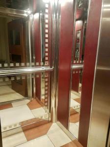 a row of glass doors in a elevator at Bright Top Floor Studio-Apartment in Kalamaki in Athens