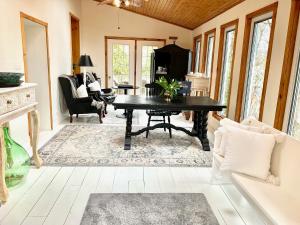 a living room with a black table and chairs at Plantation House Bed & Breakfast in Port Hope