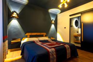 a bedroom with a bed in a room with lights at CHALET VERDE in Kirazlı