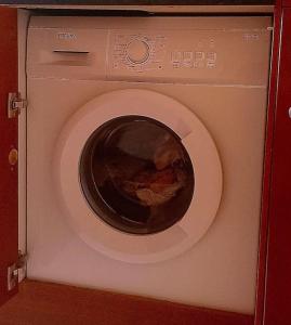 a washing machine with its door open in a room at Cozy haven near Paris La Defense Grande Arche in Courbevoie