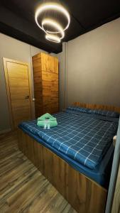 a bed in a room with a blue mattress at KOCHEVNIK HOSTEL in Almaty