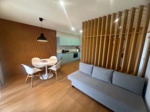 a living room with a couch and a table and chairs at Francisco Barbosa in Estarreja
