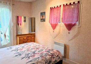 - une chambre avec un lit doté de rideaux roses et d'une fenêtre dans l'établissement Chalet au Lac de Maguide, à Biscarrosse