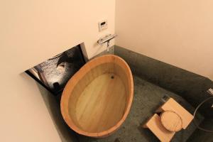 a bathroom with a wooden tub and a toilet at Our-Turn Traditional Machiya near Heian Shrine in Kyoto