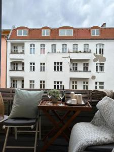 a table and chairs on a balcony with a building at 2Room Apartment in Best Place in Berlin